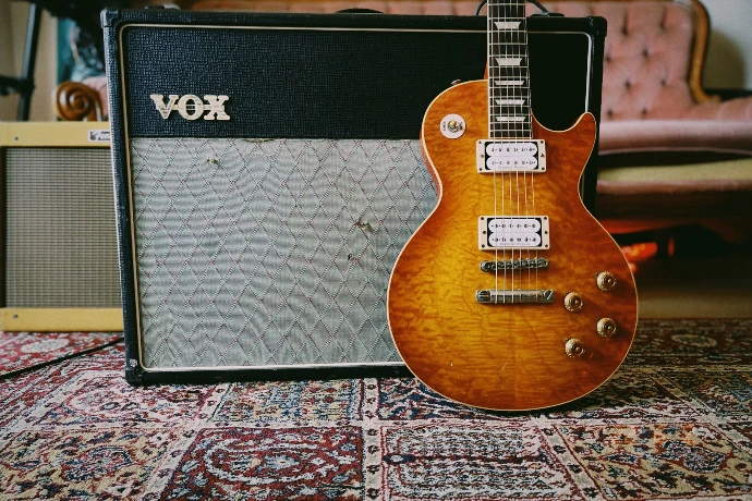 Gibson Les Paul guitar in from of a Vox AC30 guitar amplifier